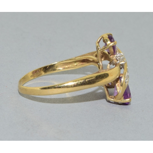 53 - 9ct gold ladies Amethyst twist ring with an open work design size T, 2.4grams