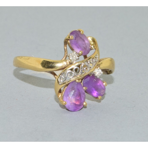 53 - 9ct gold ladies Amethyst twist ring with an open work design size T, 2.4grams