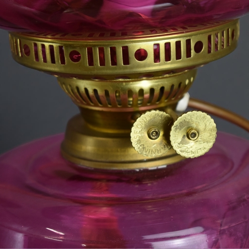 11 - A Cranberry glass Oil lamp.Converted to electric.Height - 49cm