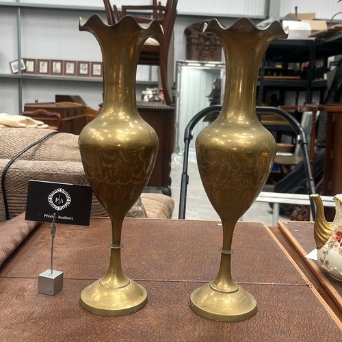 61 - Pair of turned brass vases with wavy everted rims, baluster bodies finely etched with foliate motifs... 