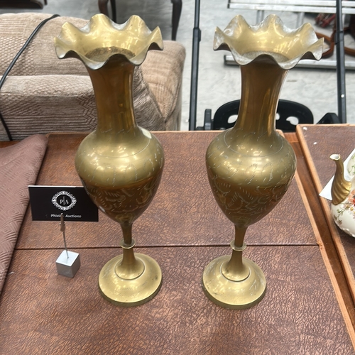61 - Pair of turned brass vases with wavy everted rims, baluster bodies finely etched with foliate motifs... 