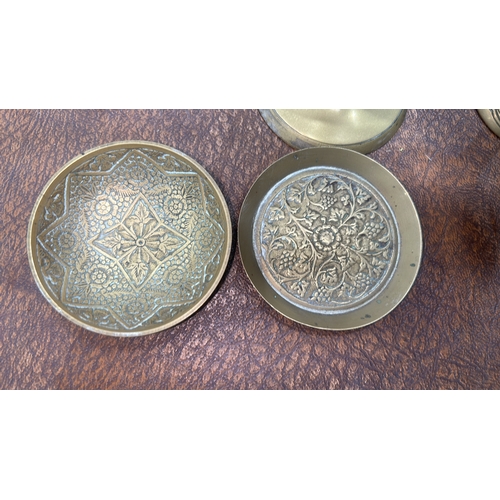 62 - Group of six Indian engraved brass wares: three stemmed goblets, a squat pot and two circular dishes... 