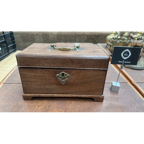12 - Rectangular mahogany single-lid tea caddy with brass swing carrying handle, pierced escutcheon and b... 