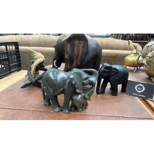9 - Four African hand-carved ornaments: mottled green serpentine elephant with calf, grained hardwood el... 