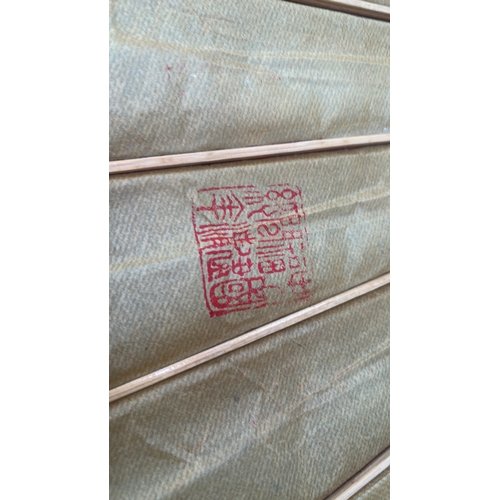 55 - Pair of bamboo-ribbed oiled-paper parasols; one cream ground with polychrome floral sprays, the othe... 