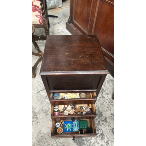 10 - Oak sewing work cabinet, rectangular form with hinged tufted silk lid, interior compartment and thre... 