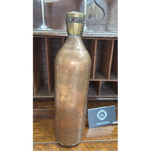65 - Hand-made cylindrical brass bottle, rounded shoulders, threaded neck and screw cap, interior unlined... 