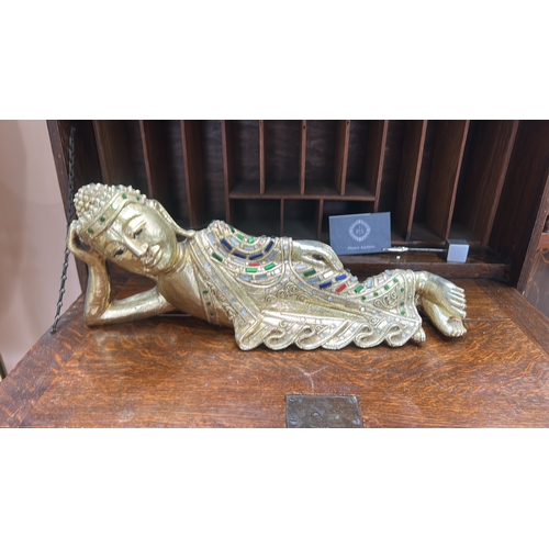 53 - Carved wooden figure of the reclining Buddha, gilt and embellished with coloured glass mosaic and ca... 