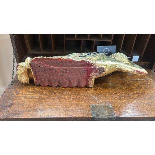 53 - Carved wooden figure of the reclining Buddha, gilt and embellished with coloured glass mosaic and ca... 