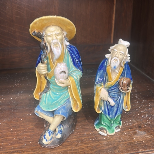 50 - Pair of Chinese Shiwan style glazed earthenware ‘mudman’ figures, each depicting a sage with staff a... 
