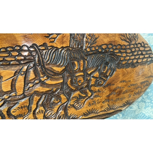 31 - a “G. Solf” panel deeply relief-carved with a farmer ploughing behind two horses before a dry-stone ... 