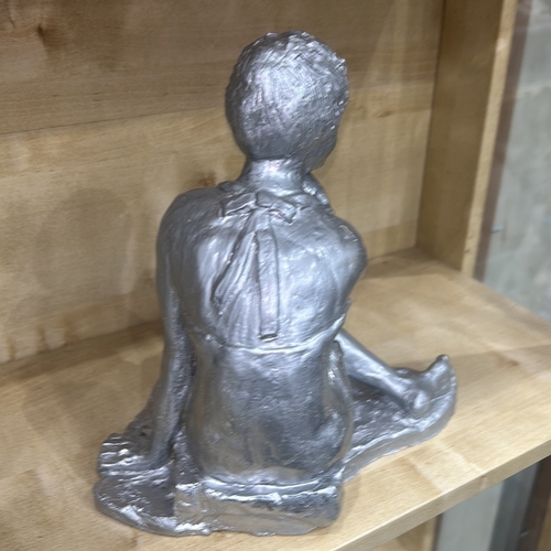 34 - Silver-painted plaster figure of a seated contemplative nude woman, legs crossed and chin resting on... 