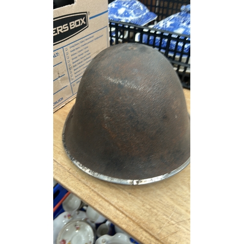 24 - steel combat helmet lacking liner and chinstrap.