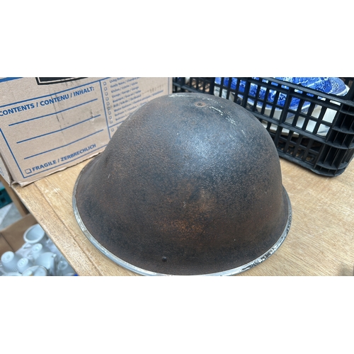 24 - steel combat helmet lacking liner and chinstrap.