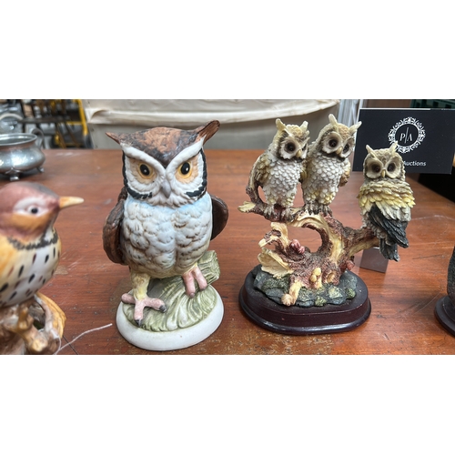 35 - Group of six small bird sculptures—owls, songbirds, and gull—modelled in painted ceramic and resin o... 