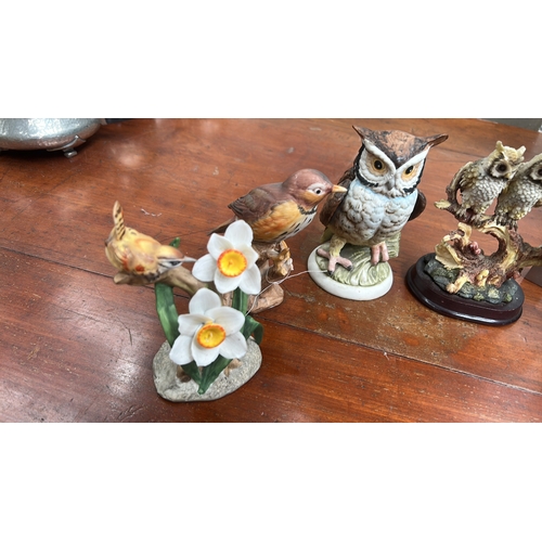 35 - Group of six small bird sculptures—owls, songbirds, and gull—modelled in painted ceramic and resin o... 