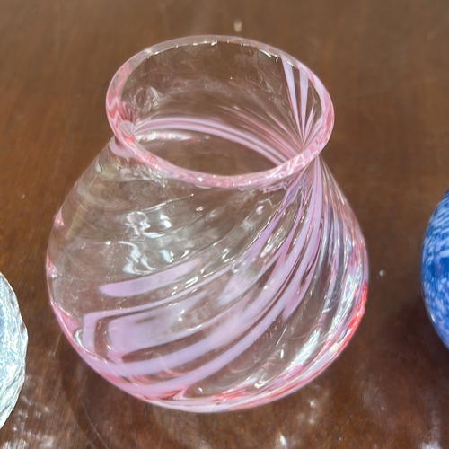 36 - Group of four hand-blown studio art glass pieces: clear ice-textured votive, pink spiral miniature v... 