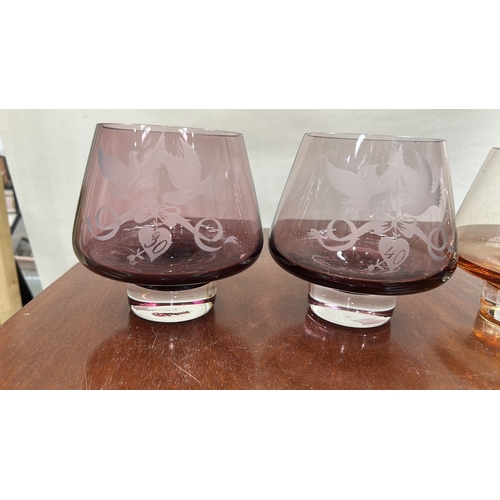 37 - Caithness Glass group of four engraved coloured crystal pieces: three low conical tumblers in amethy... 