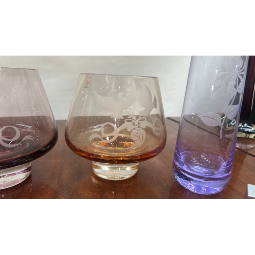 37 - Caithness Glass group of four engraved coloured crystal pieces: three low conical tumblers in amethy... 