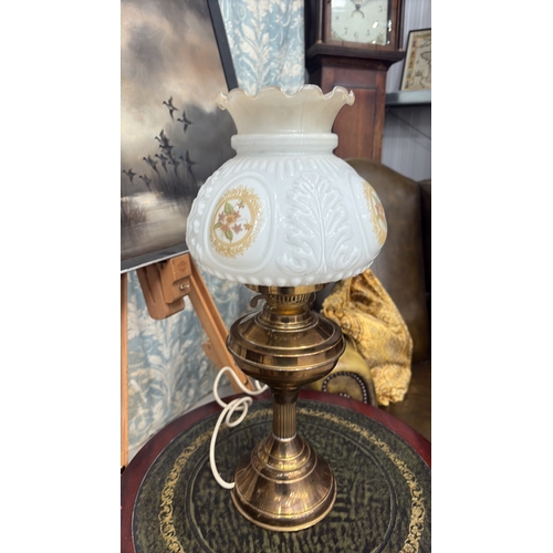 23 - Electrified brass table lamp with baluster oil font and fluted column, fitted with moulded milk glas... 