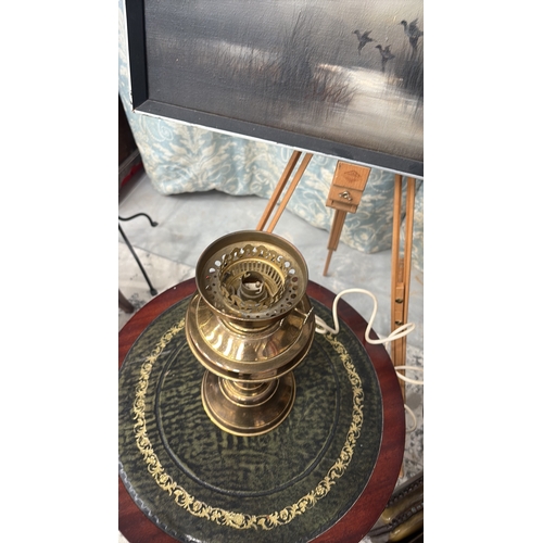 23 - Electrified brass table lamp with baluster oil font and fluted column, fitted with moulded milk glas... 