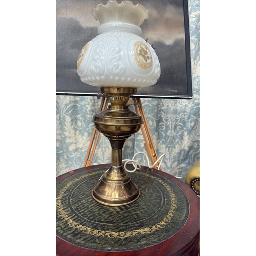 23 - Electrified brass table lamp with baluster oil font and fluted column, fitted with moulded milk glas... 