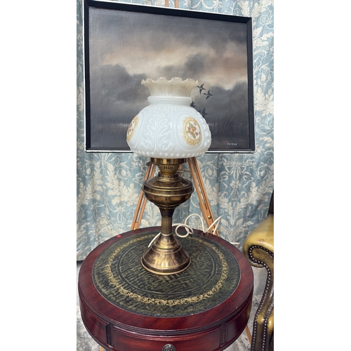 23 - Electrified brass table lamp with baluster oil font and fluted column, fitted with moulded milk glas... 