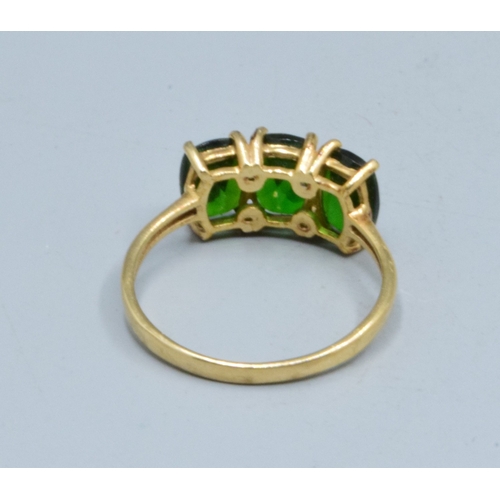 3 - 9ct gold ladies 3 stone Grossular Garnet ring the head being 14mm wide the height being 7mm tall in ... 
