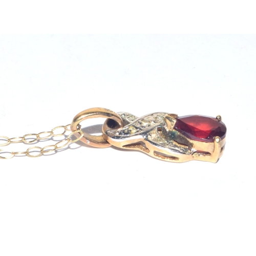 24 - 9ct gold Diamond and red gem stone pendant necklace on a 9ct gold chain of 40cm