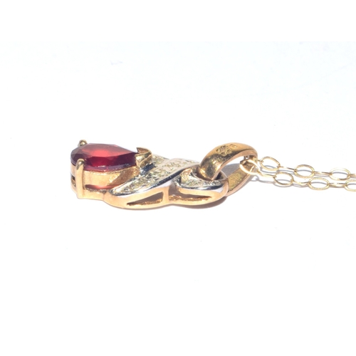 24 - 9ct gold Diamond and red gem stone pendant necklace on a 9ct gold chain of 40cm