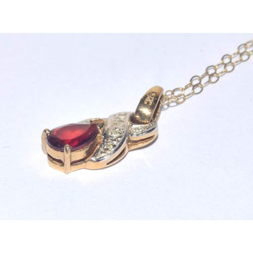 24 - 9ct gold Diamond and red gem stone pendant necklace on a 9ct gold chain of 40cm