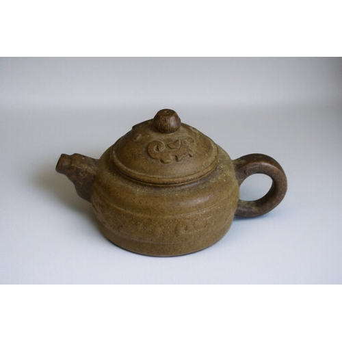 271 - A Chinese Yixing Zisha clay teapot.Relief decorated. Signed to base and lid.7.5 x 13cm
