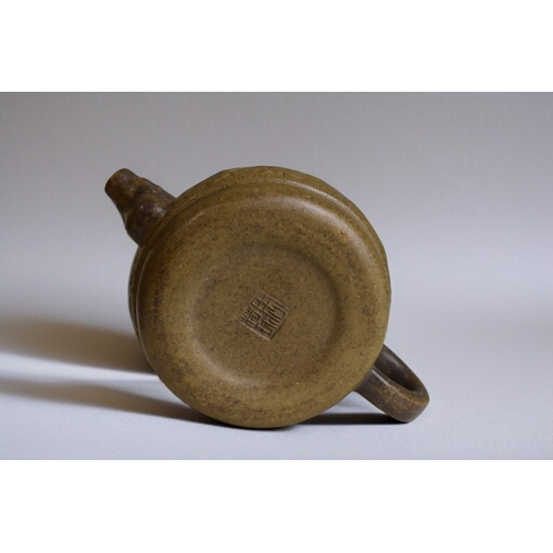 271 - A Chinese Yixing Zisha clay teapot.Relief decorated. Signed to base and lid.7.5 x 13cm