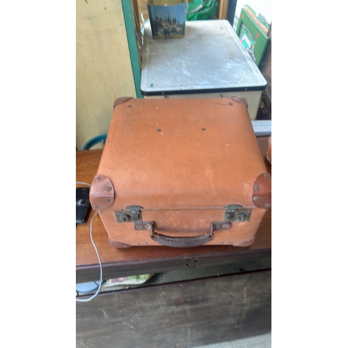 335 - Rectangular tan leather suitcase with stitched edges, riveted corner protectors, twin brass locks, a... 