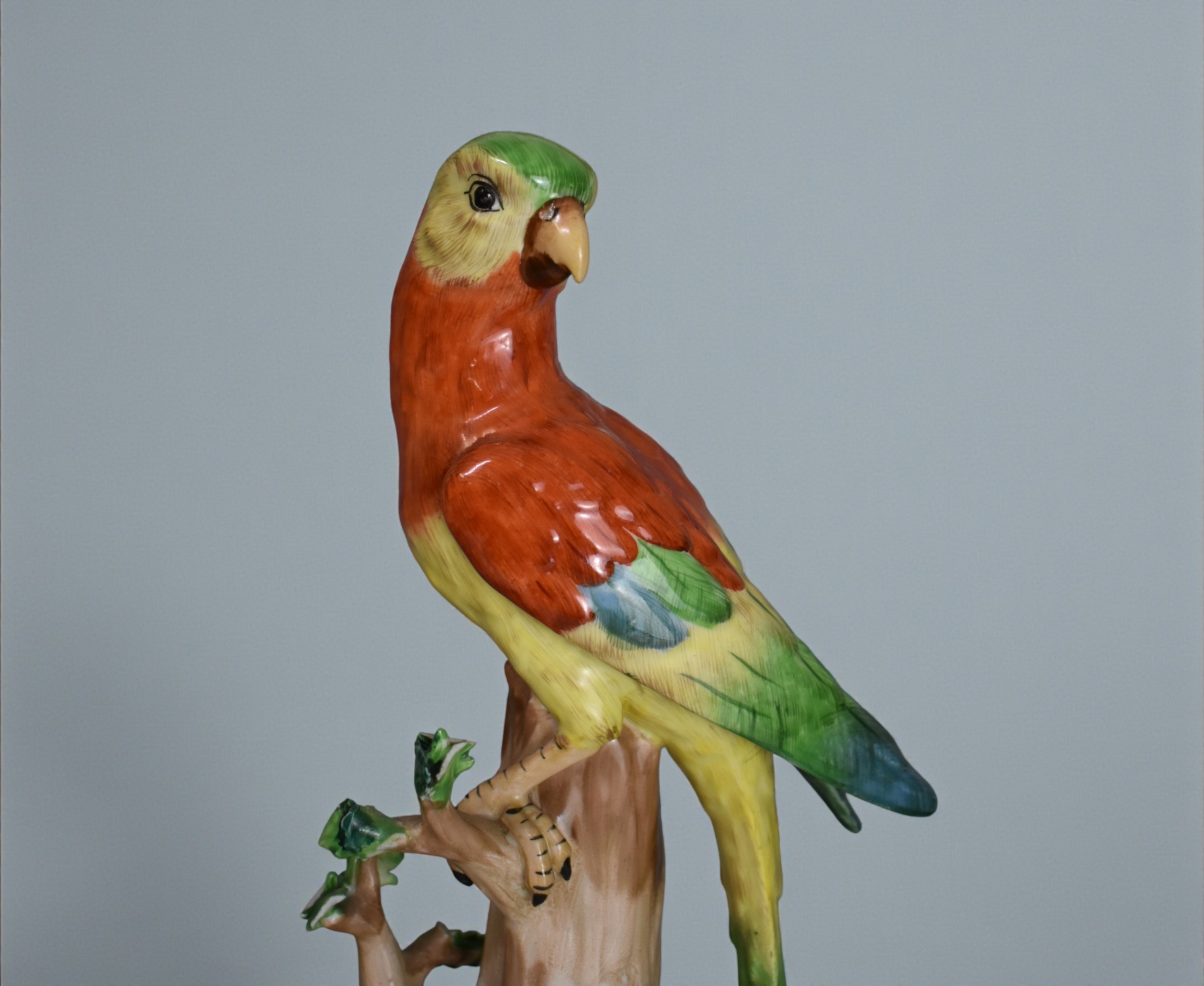A pair of Carl Thieme Dresden porcelain parrots.Height - 31cm and 29cm ...