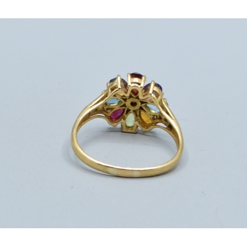 44 - Ladies multi gem set flower head ring in 9ct gold with Amethyst Peridot Garnet Ruby Aquamarine and T... 