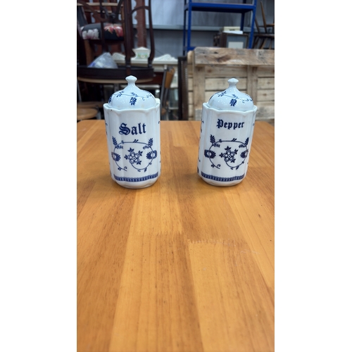 125 - Pair of cylindrical porcelain lidded salt and pepper pots, octagonal section, blue floral scroll dec... 