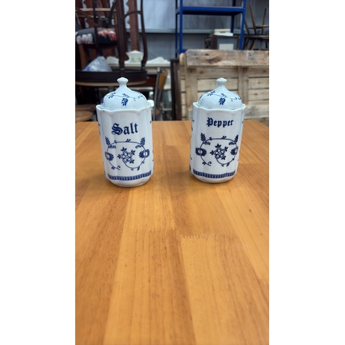 125 - Pair of cylindrical porcelain lidded salt and pepper pots, octagonal section, blue floral scroll dec... 