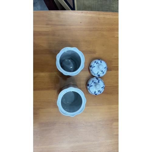 125 - Pair of cylindrical porcelain lidded salt and pepper pots, octagonal section, blue floral scroll dec... 