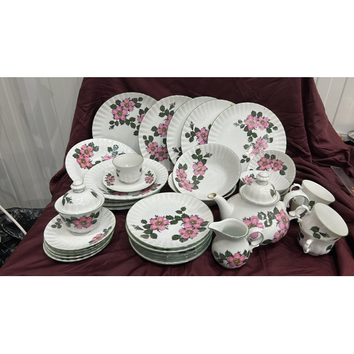 193 - Part dinner and tea service by Winterling, Bavaria, fluted white porcelain with pink wild-rose patte... 