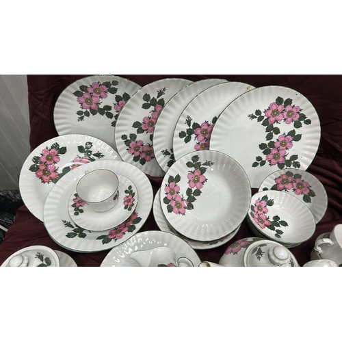 193 - Part dinner and tea service by Winterling, Bavaria, fluted white porcelain with pink wild-rose patte... 