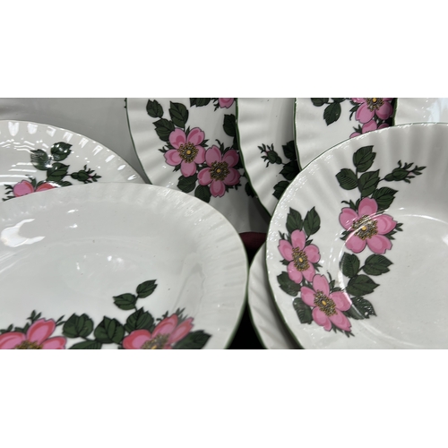 193 - Part dinner and tea service by Winterling, Bavaria, fluted white porcelain with pink wild-rose patte... 