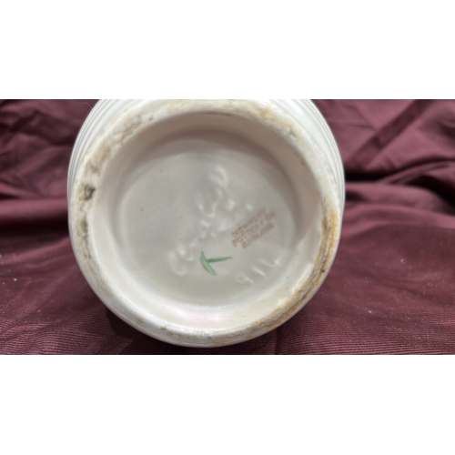 255 - Newport Pottery. Cream-glazed earthenware jug, ribbed body with polychrome moulded floral panels, br... 