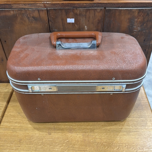 313 - Revelation hard-sided vanity case with textured brown exterior, chrome trim, hinged lid containing r... 
