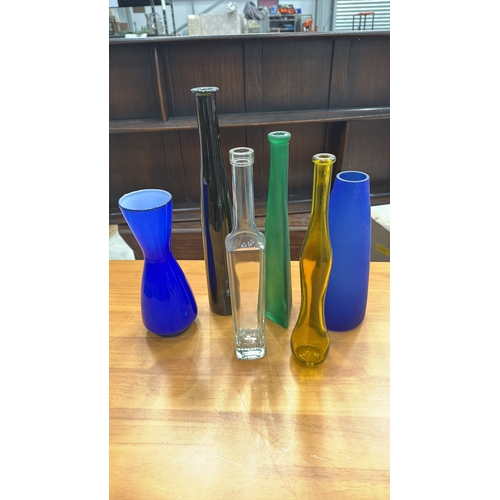324 - Set of six decorative blown and moulded glass vases/bottles in cobalt, emerald, amber, clear and obs... 