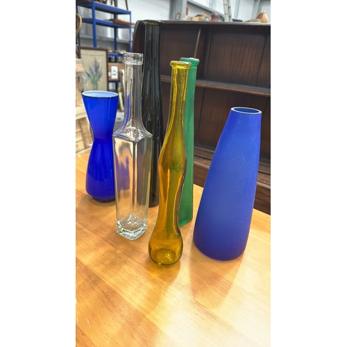 324 - Set of six decorative blown and moulded glass vases/bottles in cobalt, emerald, amber, clear and obs... 