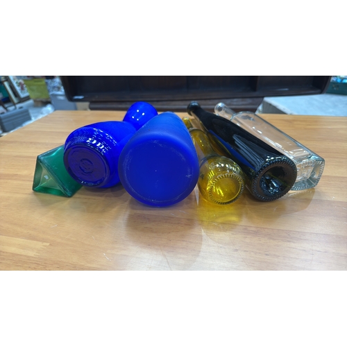 324 - Set of six decorative blown and moulded glass vases/bottles in cobalt, emerald, amber, clear and obs... 