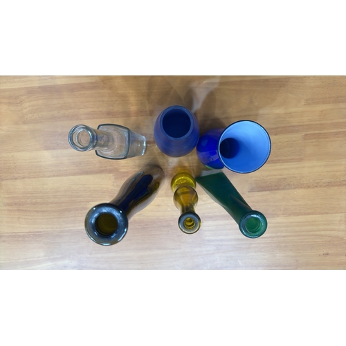 324 - Set of six decorative blown and moulded glass vases/bottles in cobalt, emerald, amber, clear and obs... 