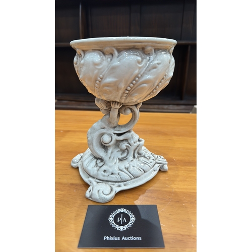 331 - Ornate glazed porcelain tazza with shell-form bowl supported by a cherub on rocaille base, underside... 