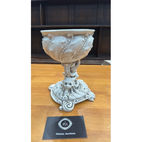 331 - Ornate glazed porcelain tazza with shell-form bowl supported by a cherub on rocaille base, underside... 